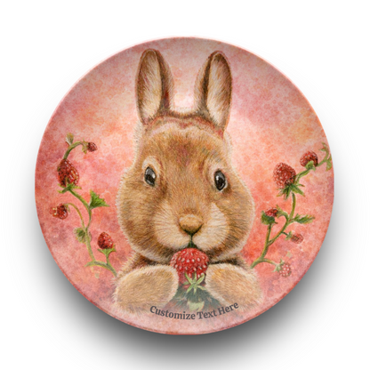 Round coaster with a rabbit holding a strawberry on a pink floral background